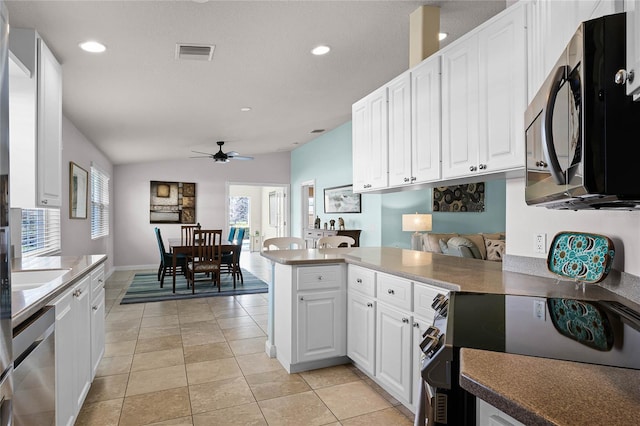 kitchen featuring electric range oven, light tile patterned floors, dishwasher, kitchen peninsula, and white cabinets