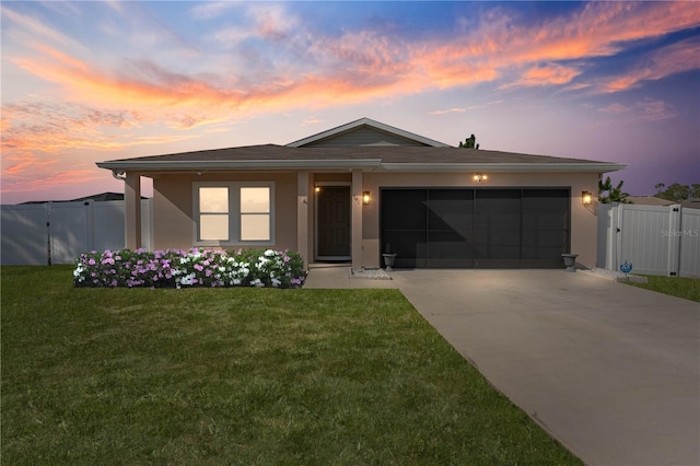 view of front of home featuring a garage and a yard