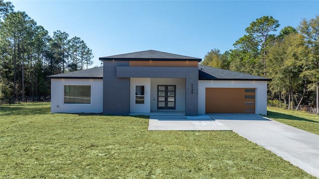 view of front of house with a garage and a front lawn