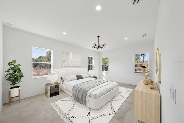 bedroom featuring multiple windows and a chandelier