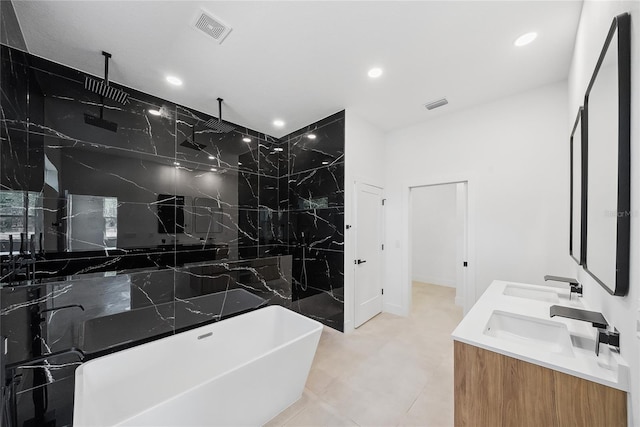 bathroom featuring vanity and independent shower and bath