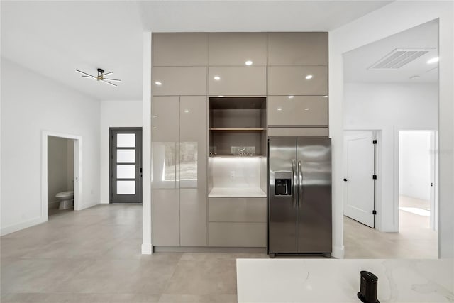 kitchen with stainless steel fridge and gray cabinets