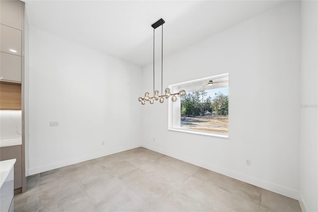 spare room featuring a chandelier