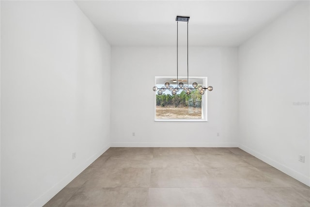 unfurnished dining area featuring a notable chandelier