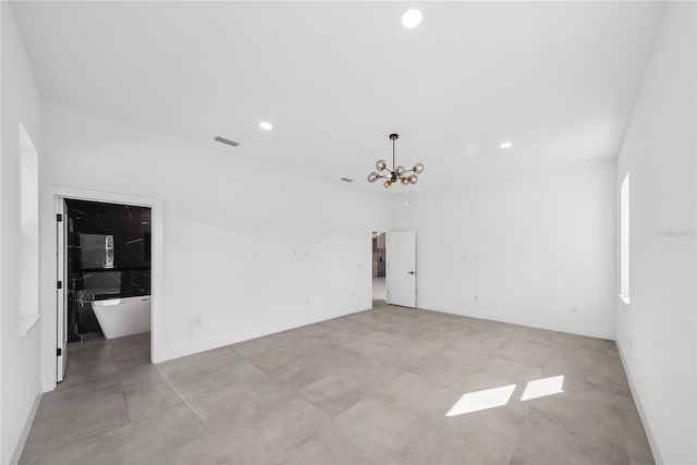 empty room with an inviting chandelier