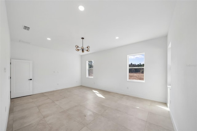 empty room featuring a notable chandelier