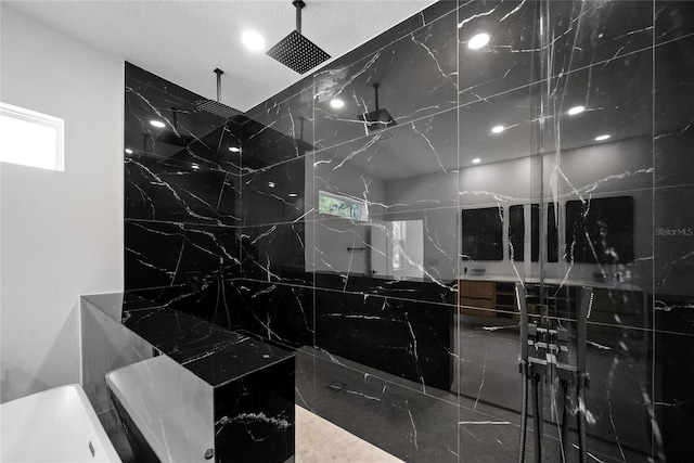 bathroom with tiled shower and a wealth of natural light