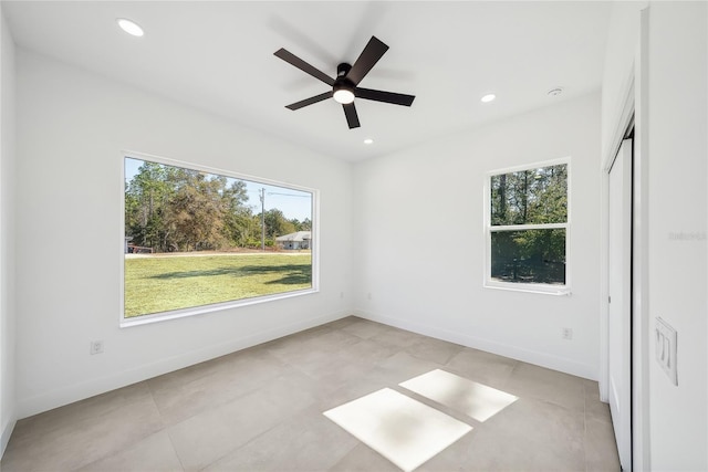 unfurnished bedroom with multiple windows and ceiling fan