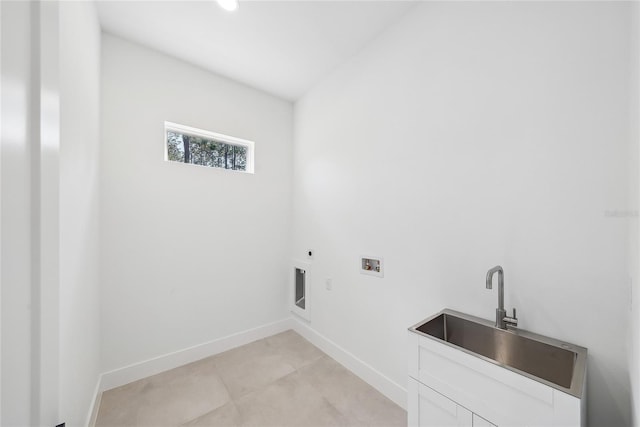 clothes washing area featuring cabinets, washer hookup, sink, and hookup for an electric dryer