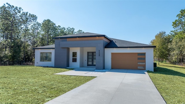 modern home with a garage and a front lawn