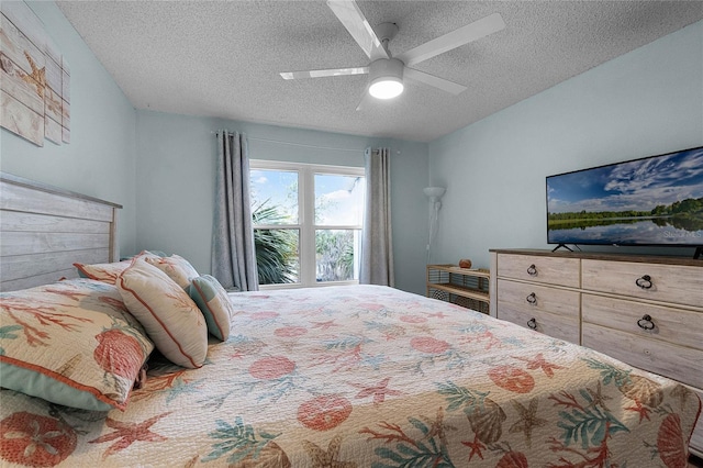 bedroom with ceiling fan and a textured ceiling