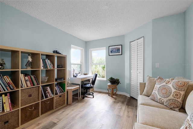 office space featuring light hardwood / wood-style floors and a textured ceiling