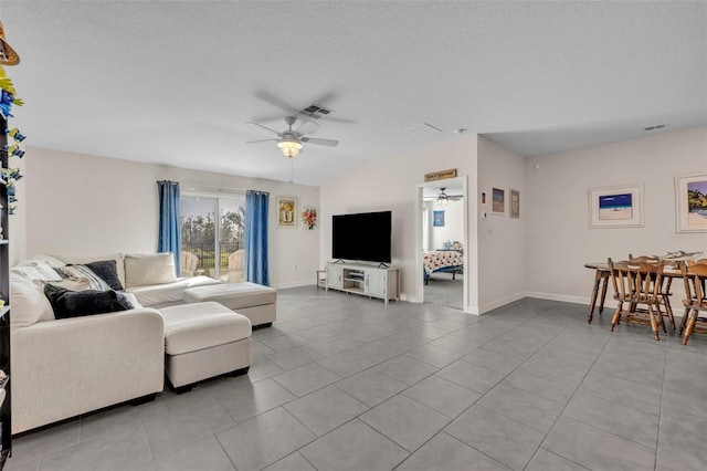 tiled living room with ceiling fan and a textured ceiling