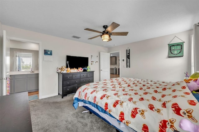 bedroom with ceiling fan, light carpet, and a textured ceiling