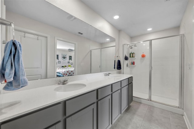 bathroom with walk in shower, tile patterned floors, and vanity