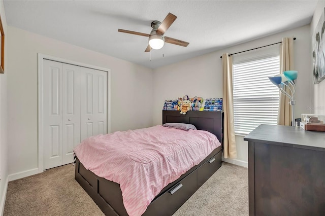 carpeted bedroom featuring a closet and ceiling fan