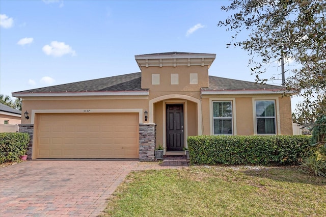 view of front of house with a garage and a front lawn