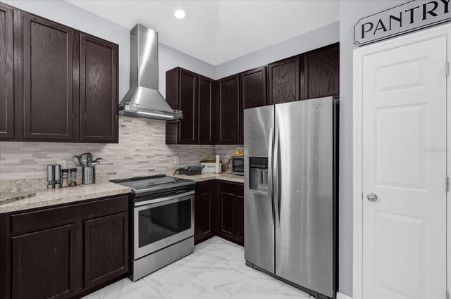 3337 Reedy Glen Dr, Kissimmee, FL 34758 - kitchen with wall chimney range hood, appliances with stainless steel finishes, dark brown cabinetry, light stone counters, and decorative backsplash