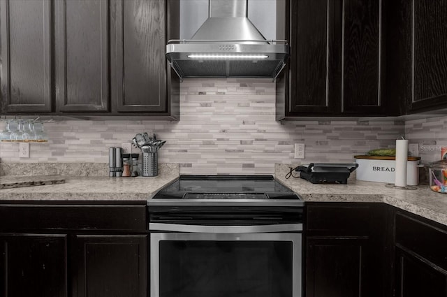3337 Reedy Glen Dr, Kissimmee, FL 34758 - kitchen featuring wall chimney range hood, decorative backsplash, and electric stove