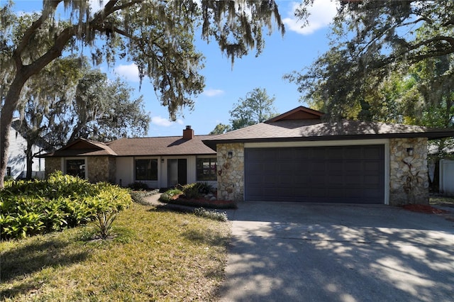 single story home with a garage and a front lawn