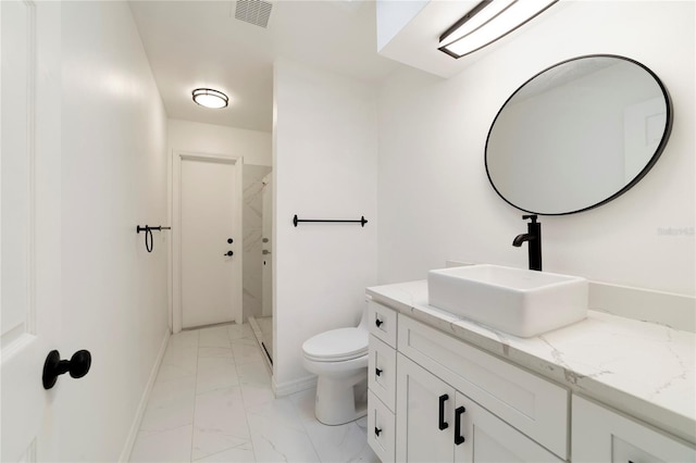 bathroom featuring vanity, toilet, and a shower