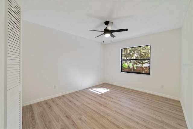 empty room featuring ceiling fan and light wood-type flooring