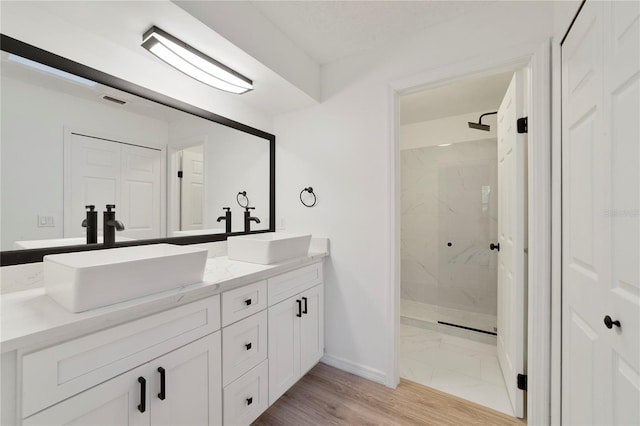 bathroom featuring vanity and a tile shower