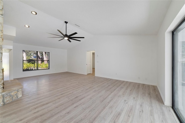 unfurnished living room with lofted ceiling, ceiling fan, and light wood-type flooring