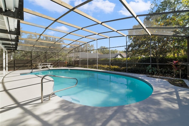 view of pool featuring a patio and glass enclosure