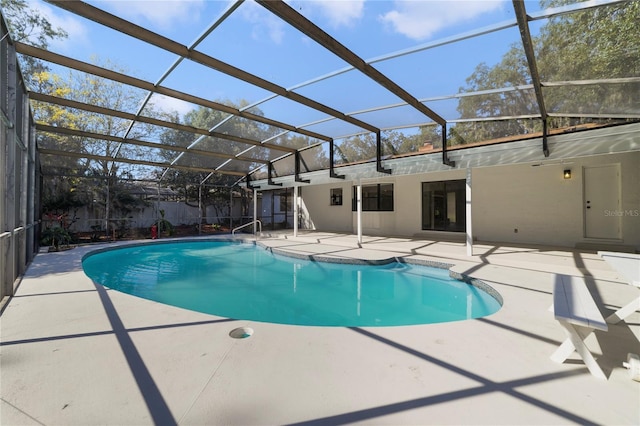 view of swimming pool featuring a lanai and a patio area