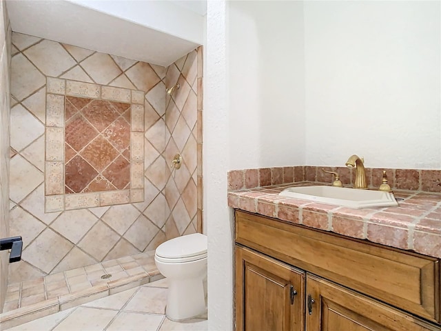 bathroom with tile patterned floors, vanity, toilet, and a shower