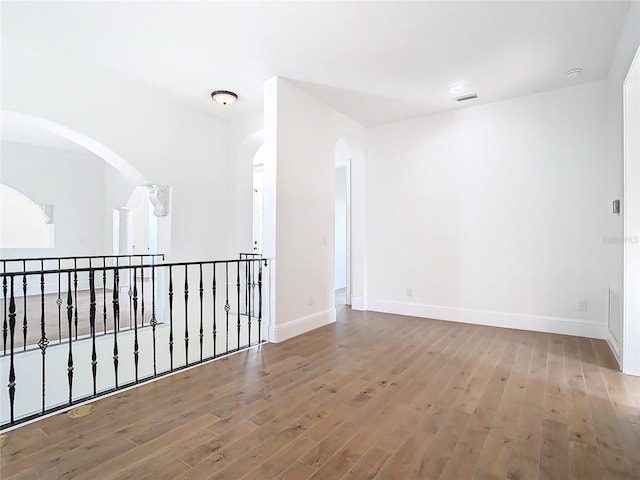 unfurnished room with wood-type flooring