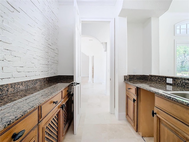 kitchen featuring dark stone countertops and sink