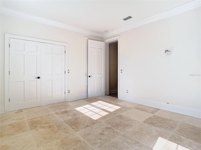 unfurnished bedroom with ornamental molding and a closet