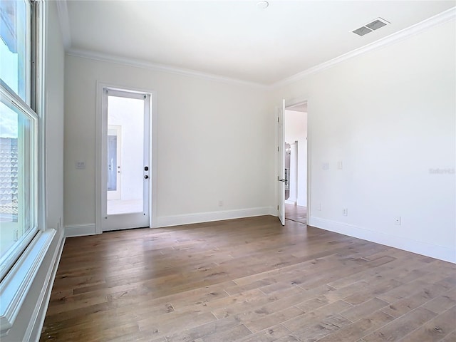 unfurnished room featuring crown molding and light wood-type flooring