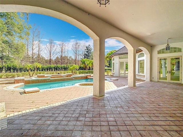 view of pool with an in ground hot tub, a patio area, ceiling fan, and french doors