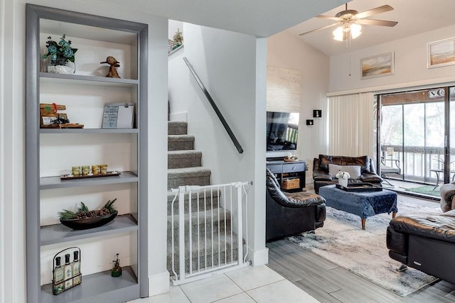 living room featuring lofted ceiling, ceiling fan, and light hardwood / wood-style flooring