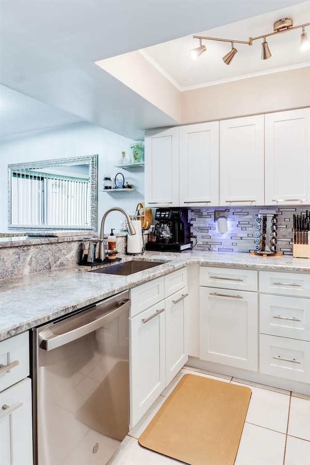 kitchen with sink, decorative backsplash, stainless steel dishwasher, and white cabinets