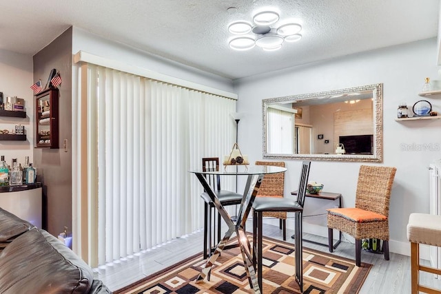 interior space with a textured ceiling and light wood-type flooring