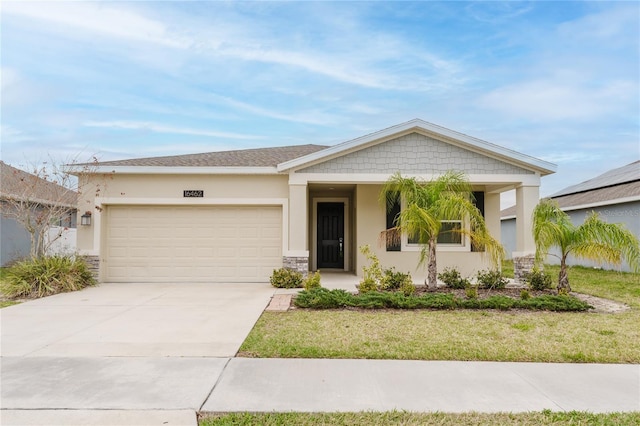 view of front of house featuring a garage and a front lawn