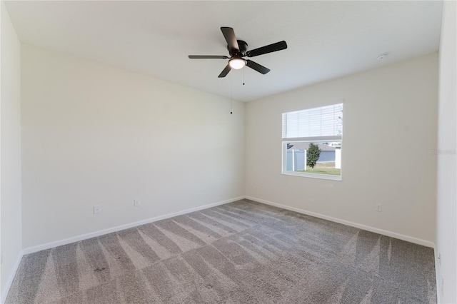 empty room featuring carpet floors and ceiling fan