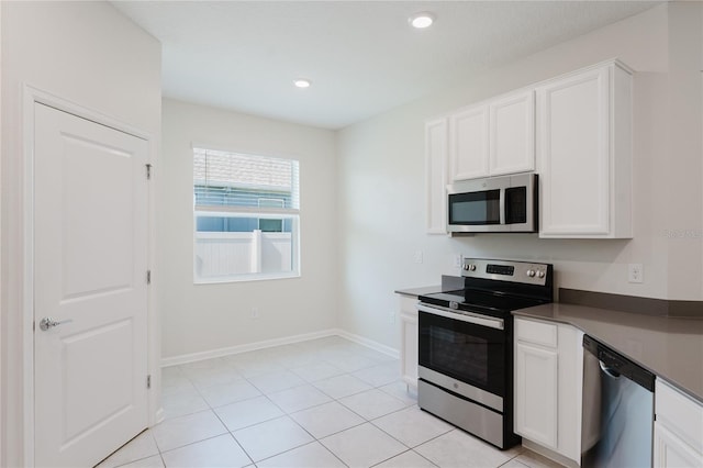 kitchen with white cabinetry, light tile patterned floors, and appliances with stainless steel finishes