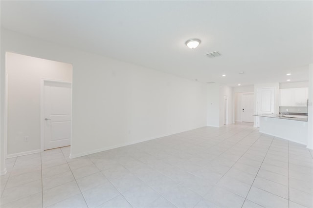 unfurnished living room with light tile patterned flooring