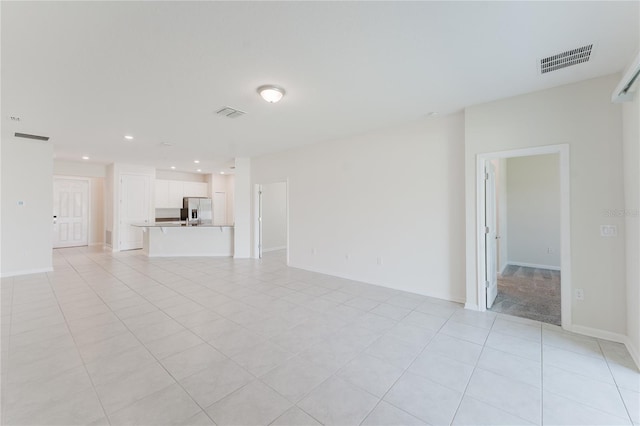 unfurnished living room with light tile patterned floors