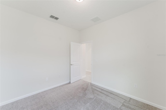 unfurnished room with light colored carpet