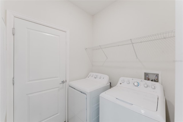 clothes washing area featuring washing machine and dryer