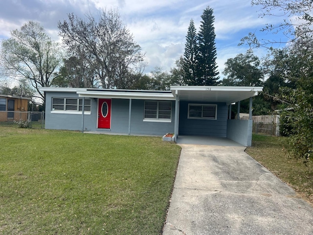 ranch-style house featuring a carport and a front yard