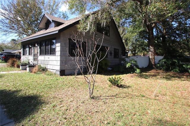 view of side of property with a yard