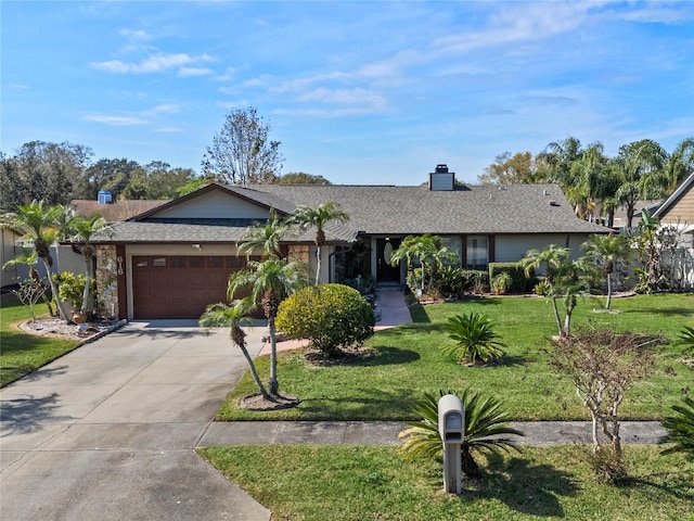 ranch-style house with a garage and a front lawn