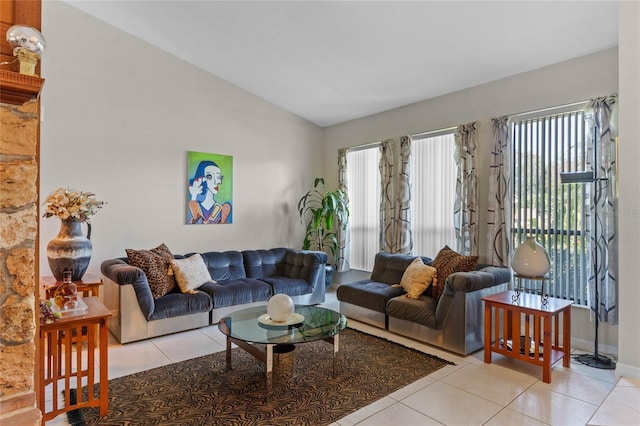 tiled living room with lofted ceiling and plenty of natural light